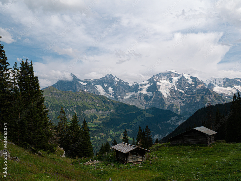Alpine wooden cabins for cheese making with a stunning view at Eiger North face, Mönch and Jungfrau in switzerland Berner Oberland