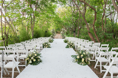 An outdoor wedding surround by big green tres photo