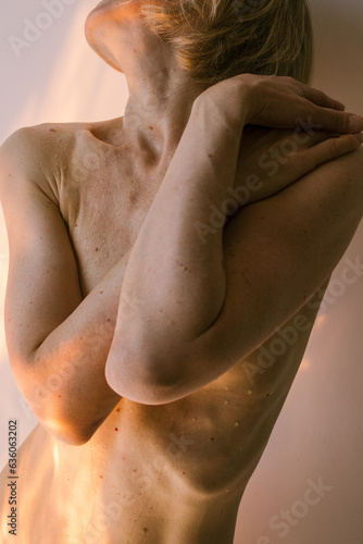 Naked female body in the sunlight 