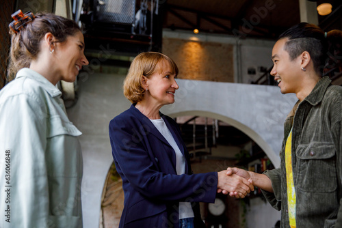 Happy business people shaking hands photo