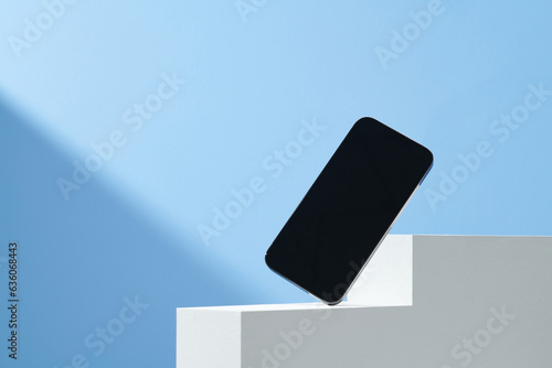 Mobile phone with a blank screen on podium