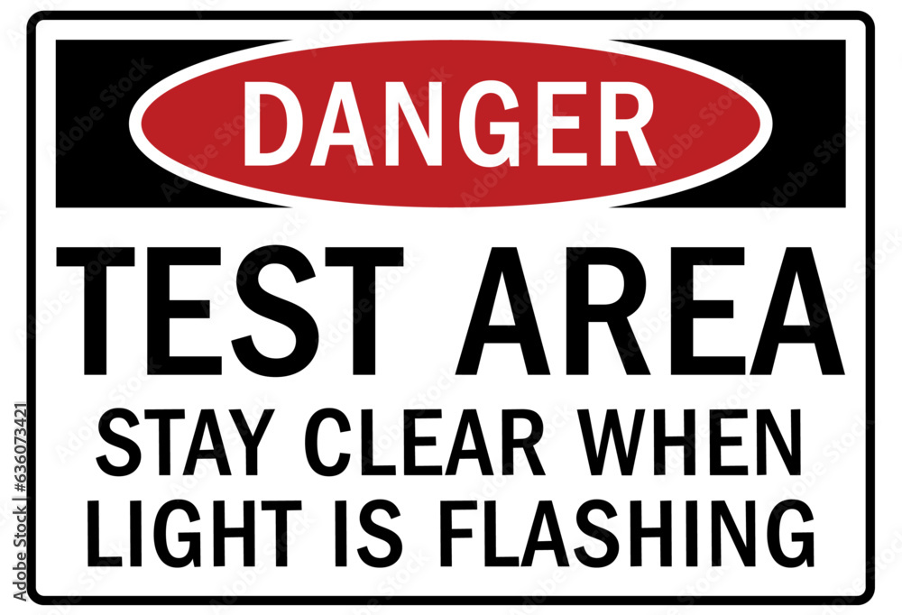 Testing in progress warning sign and labels test area. stay clear when light is flashing