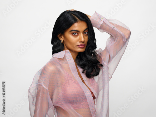 Sexy woman in see through blouse looking at camera