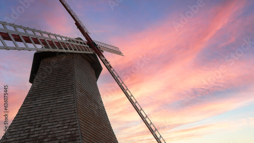 Old wooden mill against the sky at sunset time