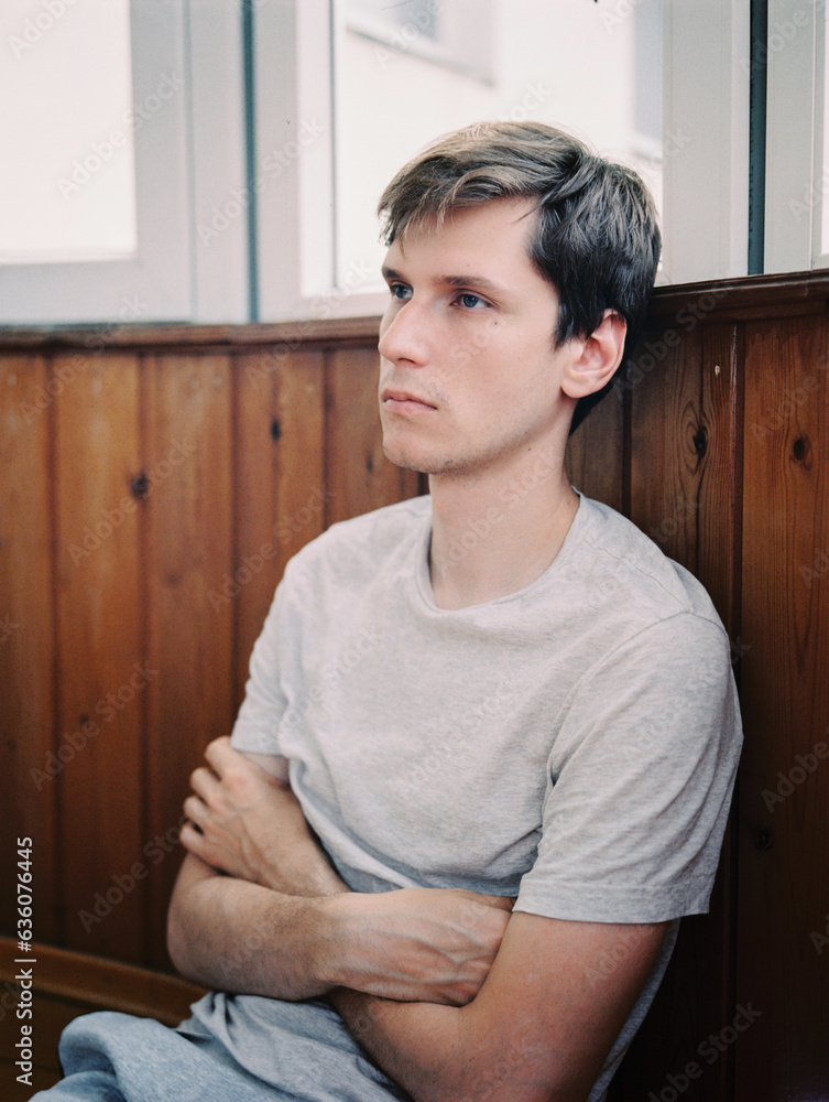 A young man rests comfortably on a balcony A young man rests comfortably on a balcony