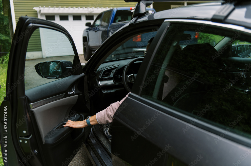 middle aged woman getting inside her car to drive somewhere middle aged woman getting inside her car to drive somewhere