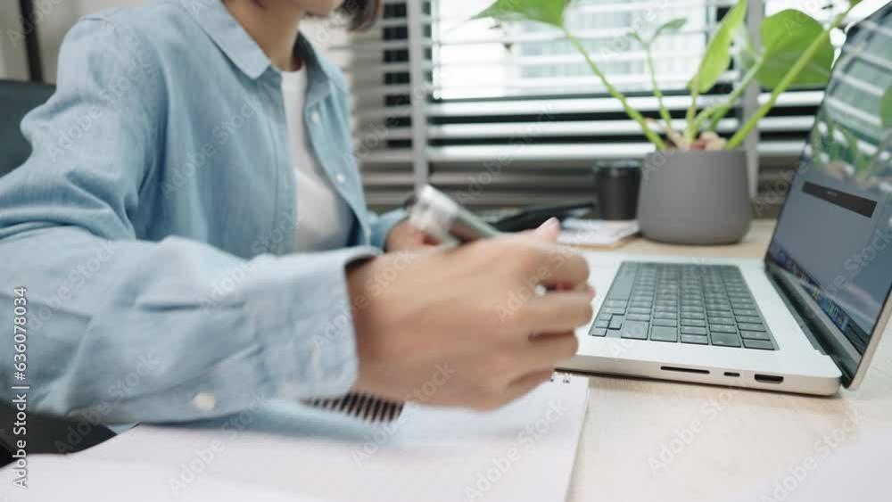 Cheerful business Asian young woman working on laptop in office work in workplace. Attractive female employee office worker smile. Cheerful business Asian young woman working on laptop in office work in workplace. Attractive female employee office worker smile.