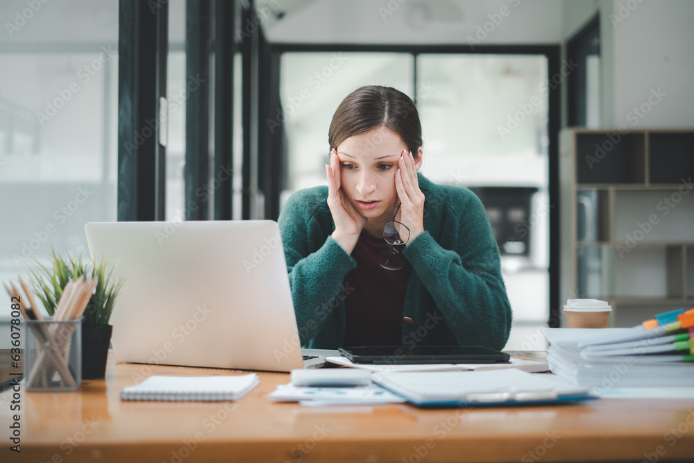 Tired businesswoman sleepy and bored from sitting at a desk for a long time and has office syndrome Tired businesswoman sleepy and bored from sitting at a desk for a long time and has office syndrome