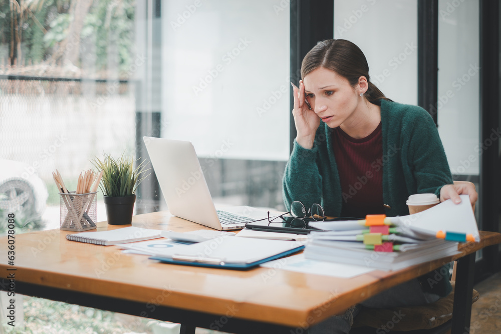 Overworked businesswoman suffering from headache and thinking how to end work. Overworked businesswoman suffering from headache and thinking how to end work.