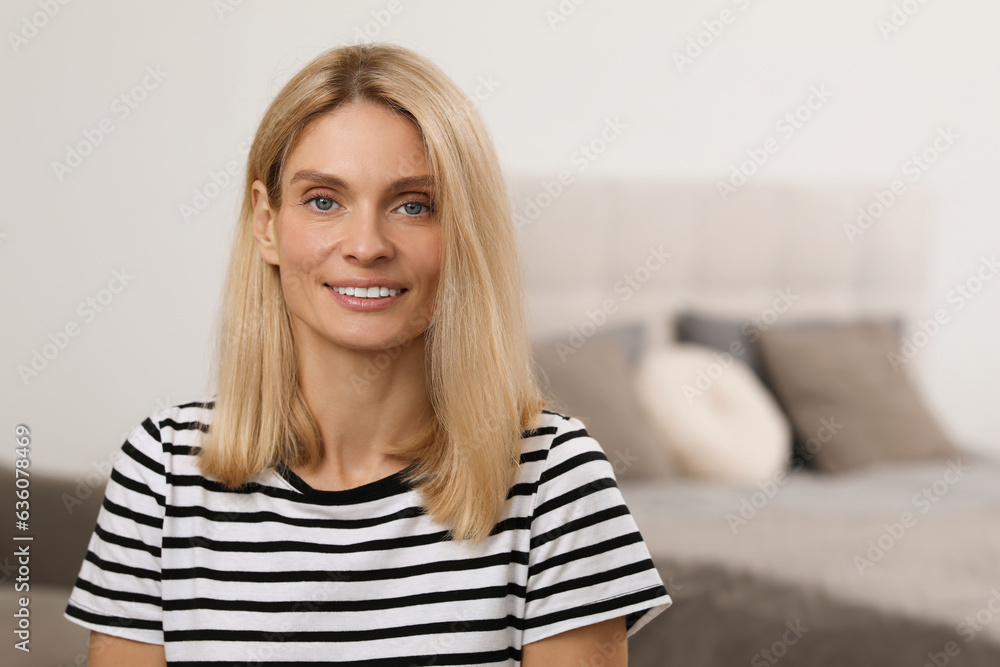 Portrait of beautiful woman with blonde hair. Attractive lady smiling and looking into camera. Space for text Portrait of beautiful woman with blonde hair. Attractive lady smiling and looking into camera. Space for text