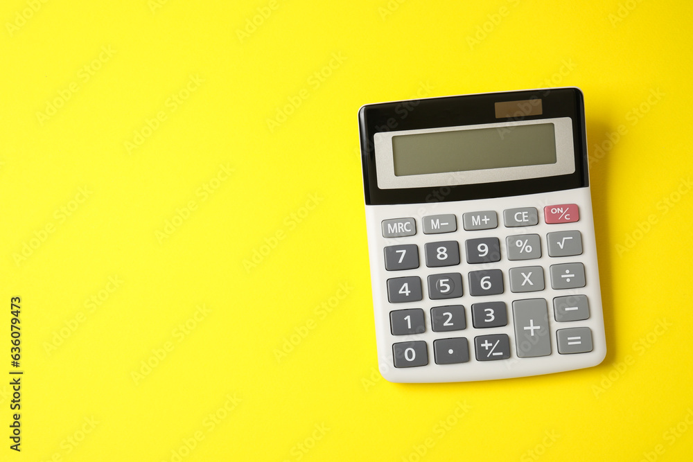 Calculator on yellow background, top view. Space for text Calculator on yellow background, top view. Space for text