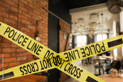 Yellow crime scene tape in empty restaurant photo