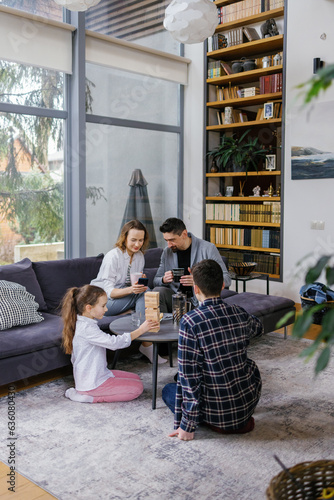 Immediate family childhood gathering living room board game home 