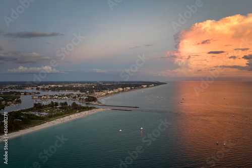 High angle view of crowded Nokomis beach in Sarasota County, USA. Many people enjoing vacations time swimming in ocean water and relaxing on warm Florida sun at sundown