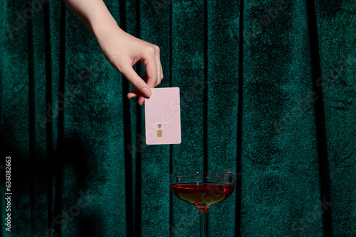 Payment for alcohol over green velvet curtain