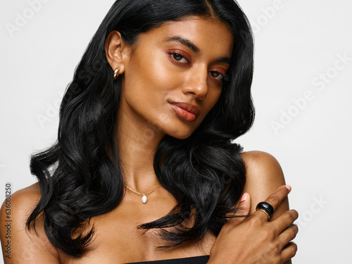 Woman with long wavy black hair close up portrait