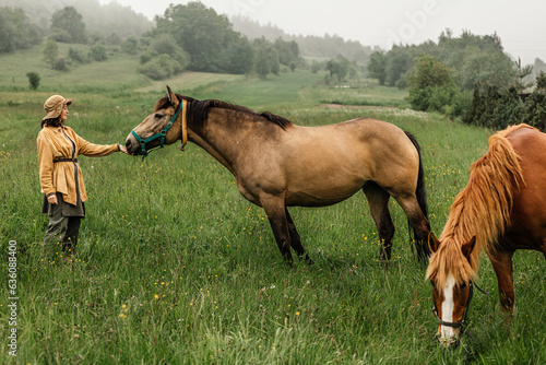 A farmer strokes his horse on a picturesque ranch photo