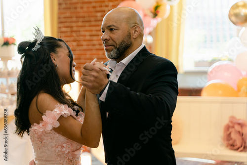 father and daughter dance during quinceanera celebration  photo