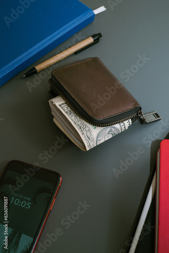 A wad of cash dollars inside the wallet at payday. 