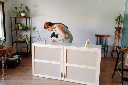 Woman working on a furniture restoration