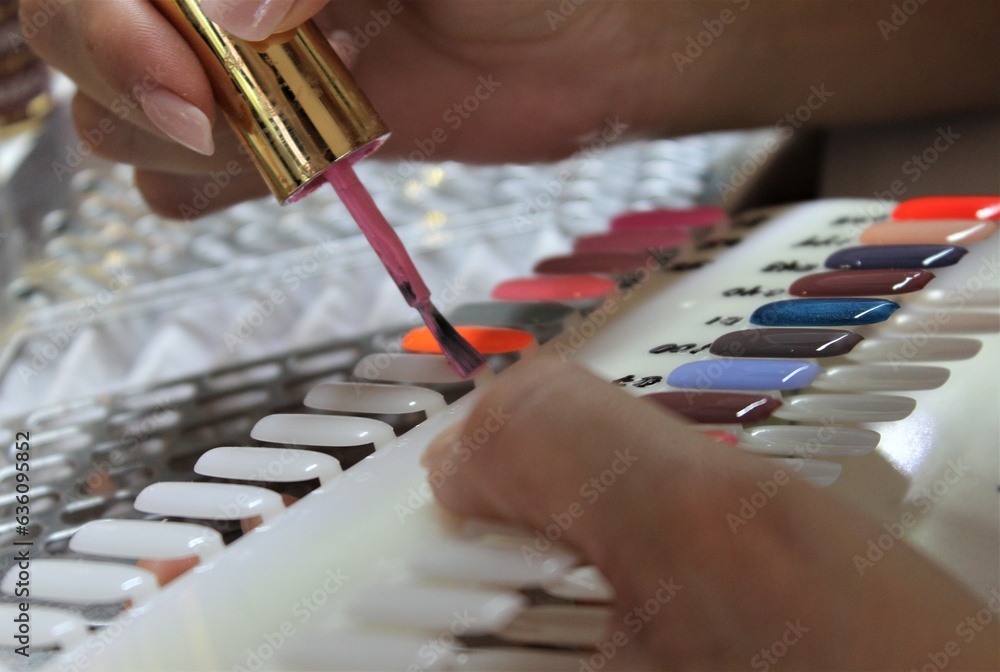 Girl prepares colors for manicure