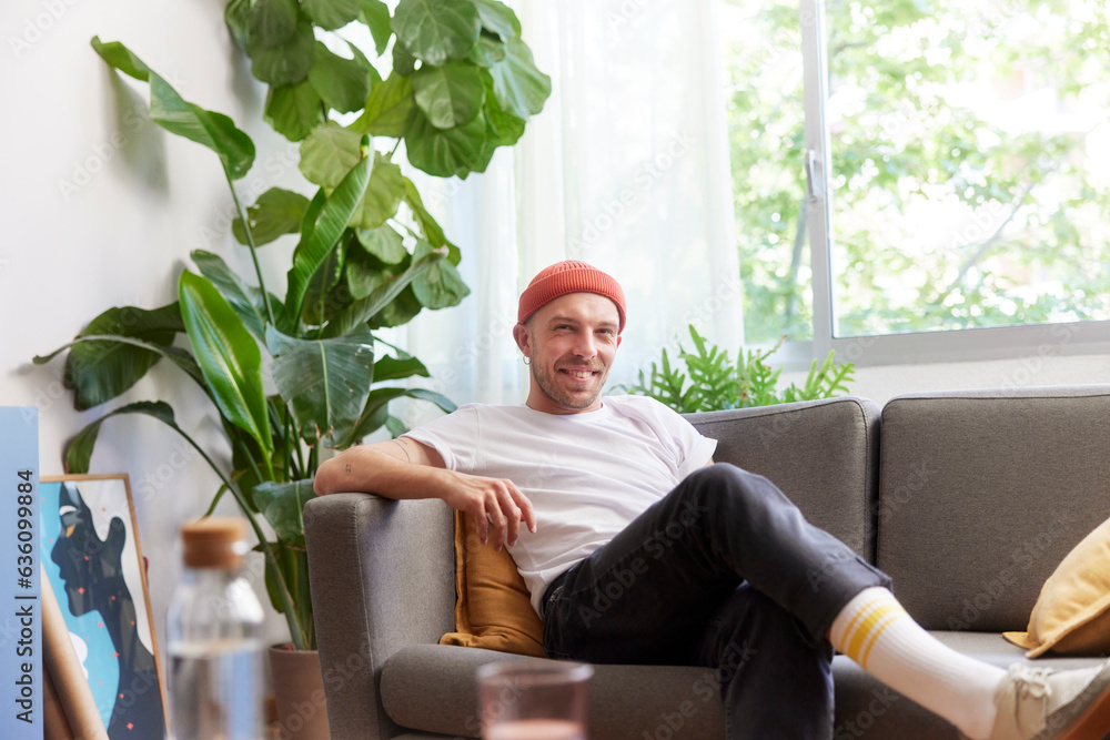 Smiling casual man resting on couch Smiling casual man resting on couch