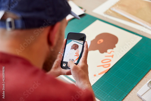 Cropped image of artist shooting creative poster on phone photo