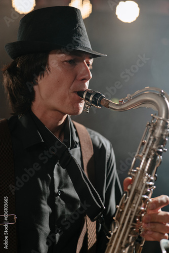 Saxophonist. Portrait of man with saxophone who plays melody