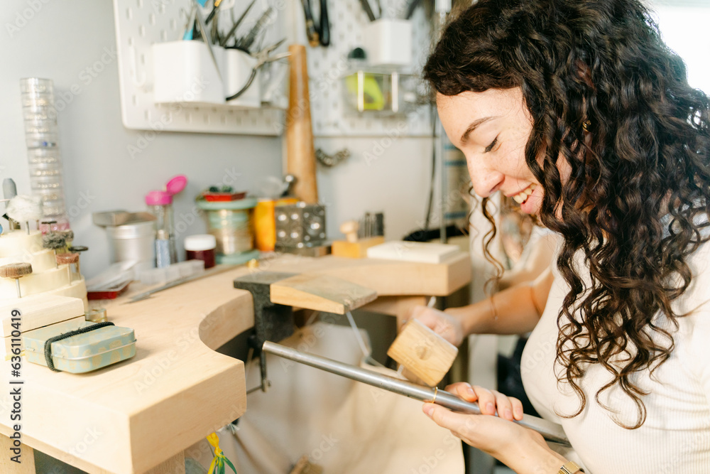 happy young woman working on jewellery happy young woman working on jewellery