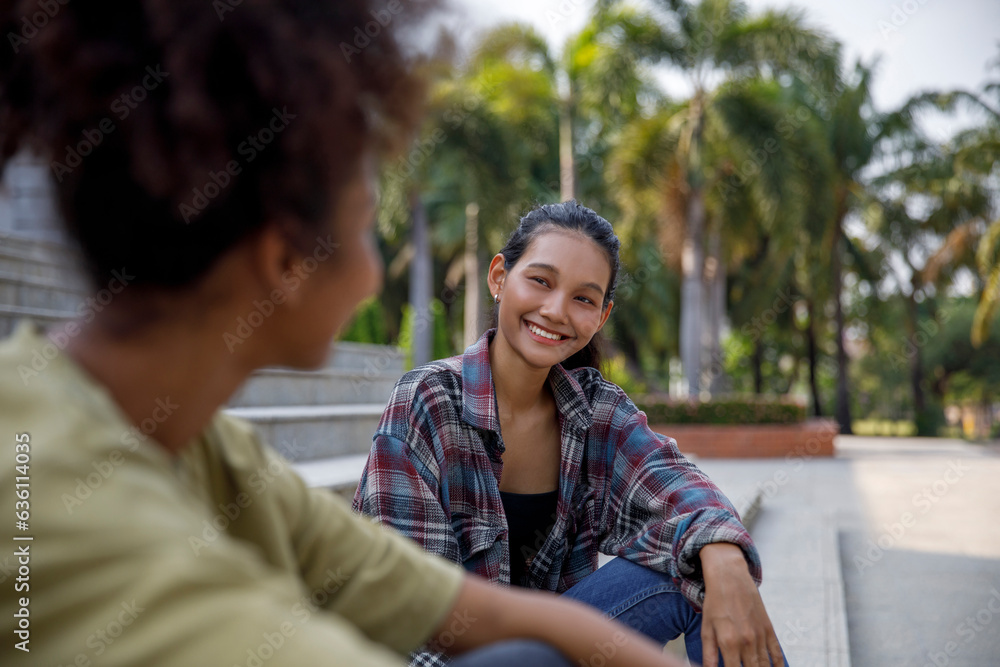 High School students having fun conversation sitting on college stairs High School students having fun conversation sitting on college stairs