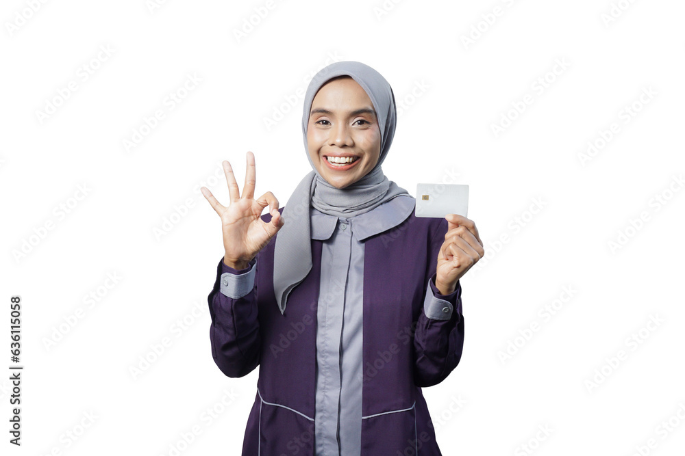 Cheerful beautiful Asian woman in casual shirt and hijab showing credit card Cheerful beautiful Asian woman in casual shirt and hijab showing credit card