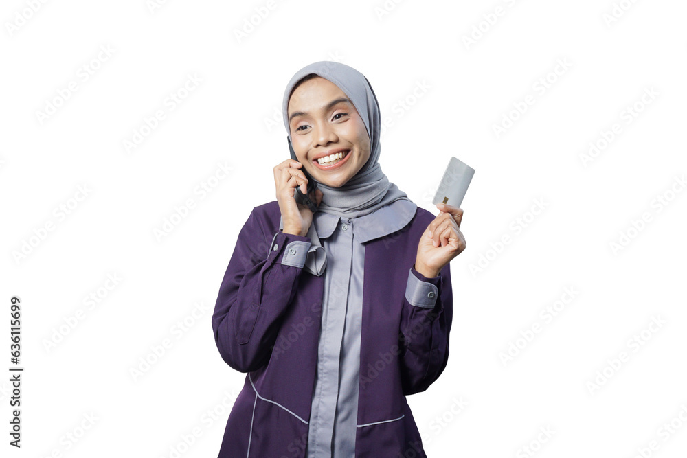 Cheerful beautiful Asian woman in casual shirt and hijab showing credit card Cheerful beautiful Asian woman in casual shirt and hijab showing credit card