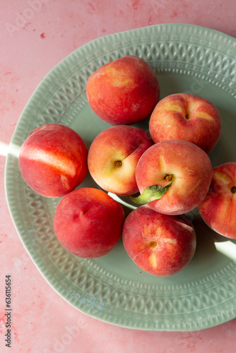 A plate of fresh white flesh peaches.  photo