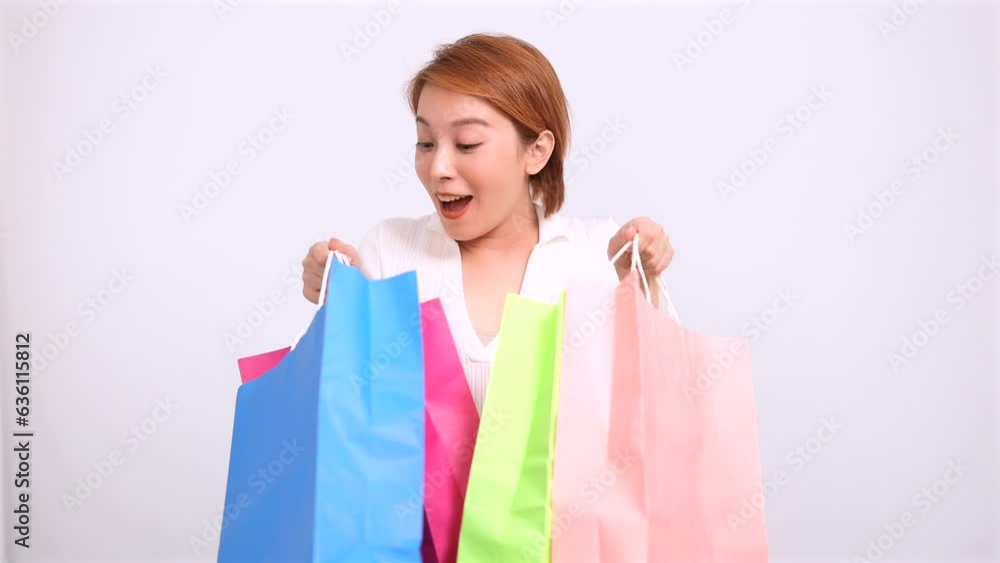 Excited young woman showing the shopping bags Excited young woman showing the shopping bags