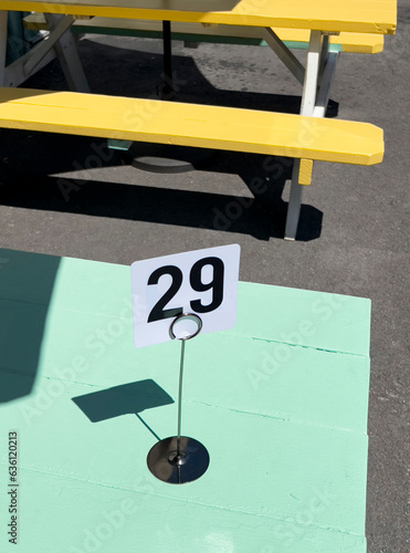Number 29 at picnic table at outdoor summer dining restaurant sign photo