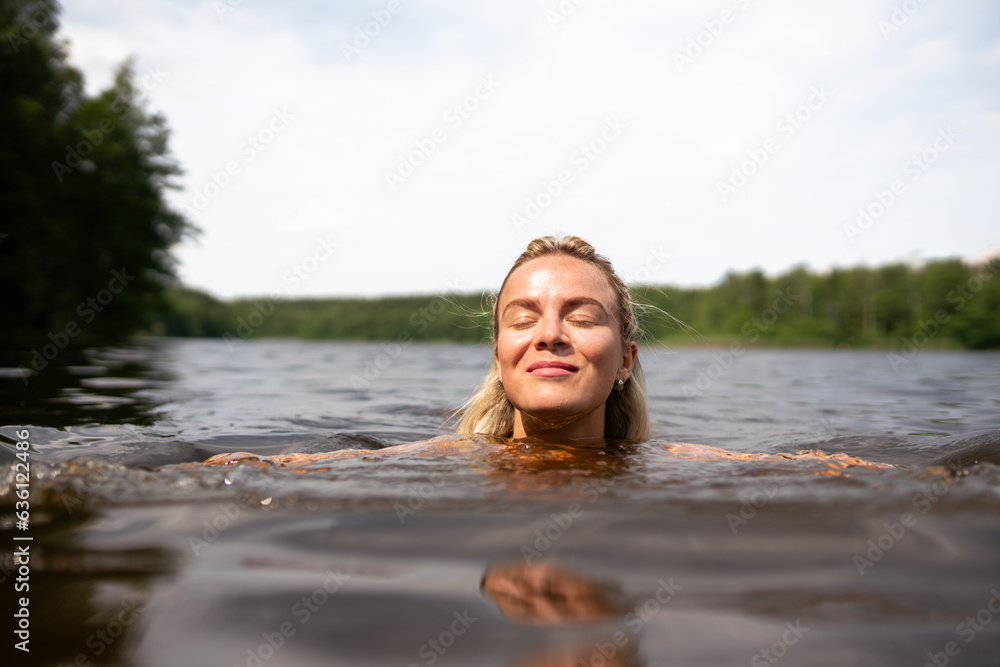 Woman Swimming In The Lake In Summer