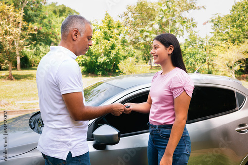 Father gives his daughter the keys to his car photo