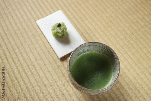 Photography Matcha tea in ceramic bowl with Japanese wagashi sweet on tatami mat top view