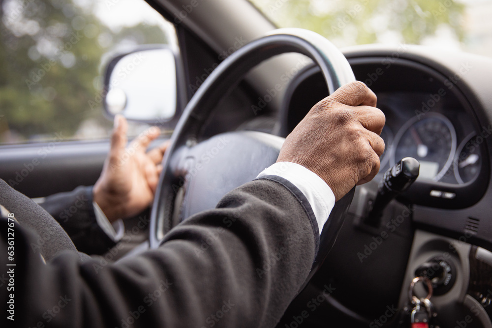 Closeup of the hand of an over 50 black woman driving a car Closeup of the hand of an over 50 black woman driving a car