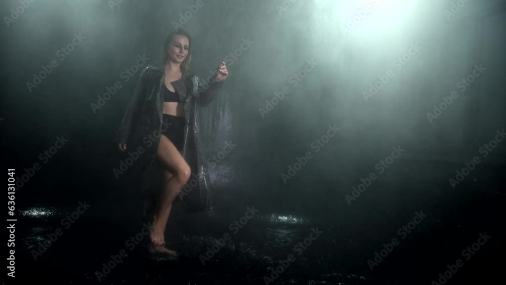 Seductive pretty wet young lady squeezes wet clothes, top standing under rain shower slow motion isolated on black studio background. Aqua studio 4k video slow motion 120 fps raw footage Seductive pretty wet young lady squeezes wet clothes, top standing under rain shower slow motion isolated on black studio background. Aqua studio 4k video slow motion 120 fps raw footage