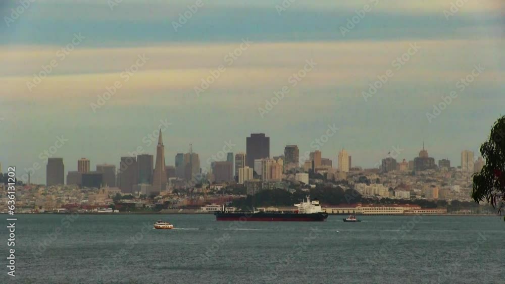Cargo Ship And Tugboat Moving In Front Of San Francisco City Scape With Cloudy Sky
Cargo Ship And Tugboat Moving In Front Of San Francisco City Scape With Cloudy Sky