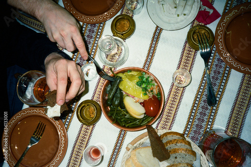 Family sharing classic russian food and celebrating with vodka