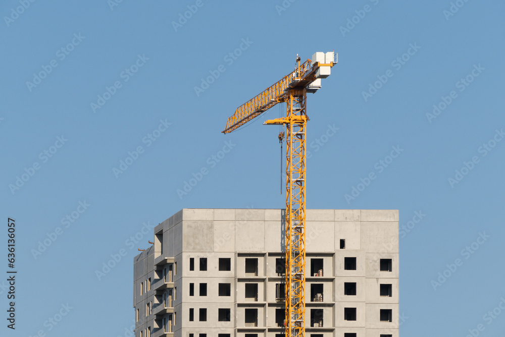 © Ilya/Stocksy - City construction site crane building © Ilya/Stocksy - City construction site crane building