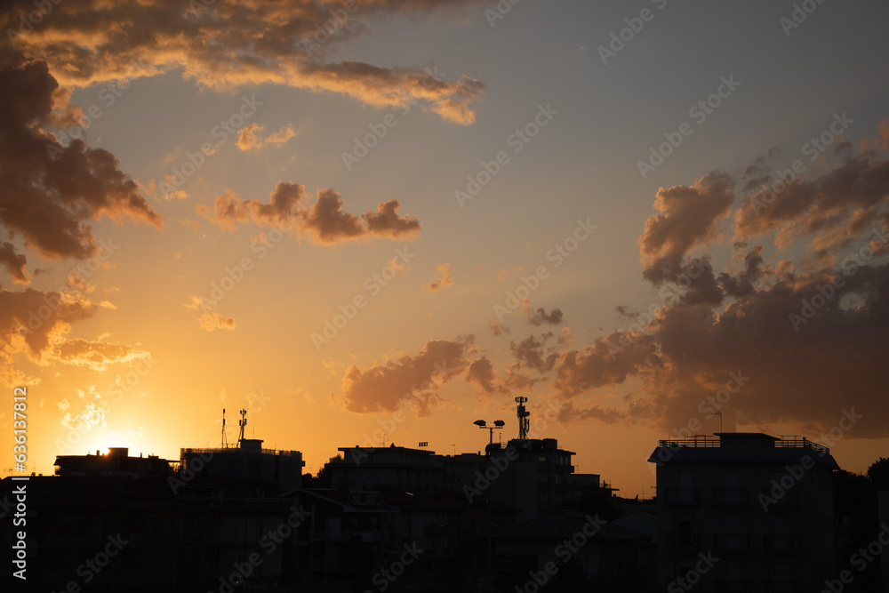 Sunset over the city in the evening, silhouette of a building