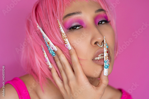 Asian woman with pink hair and trendy nails photo