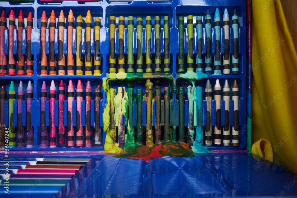 © Rowena Naylor/Stocksy - Box of crayons that have melted