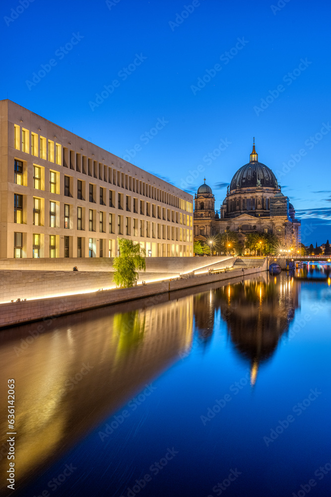 The modern backside of the City Palace, the cathedral and the river Spree in Berlin at dusk