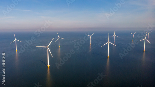 offshore windmill park alternative energy. windmills in the sea with reflection in the morning in the Netherlands