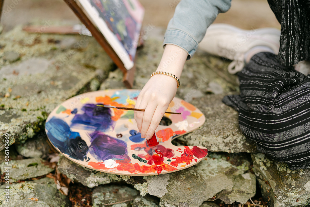 young artist squeezing paint on pallet young artist squeezing paint on pallet