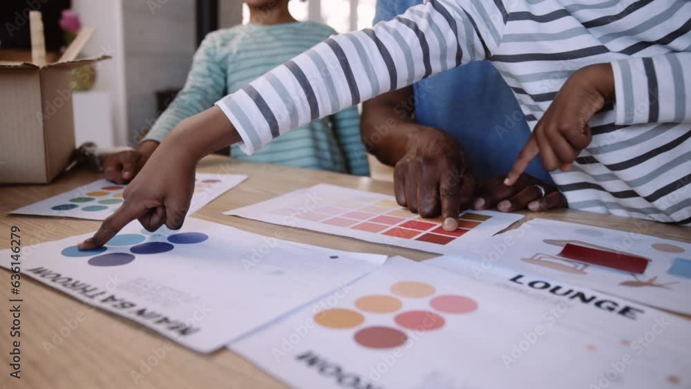 Close up hands of black father and sons pointing at colour choice for new bedroom renovation or redecorating DIY Close up hands of black father and sons pointing at colour choice for new bedroom renovation or redecorating DIY